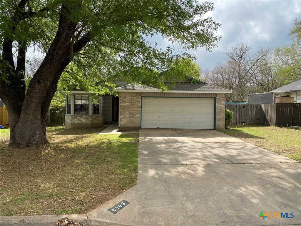 a view of a house with a yard and garage