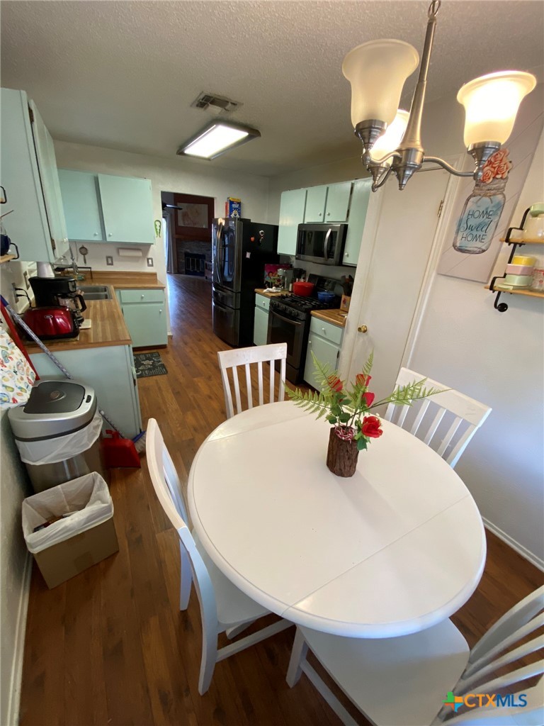 8305 Fort Sumter Road Austin, TX 78745 - Photo 17 of 23 a dining room with furniture and wooden floor