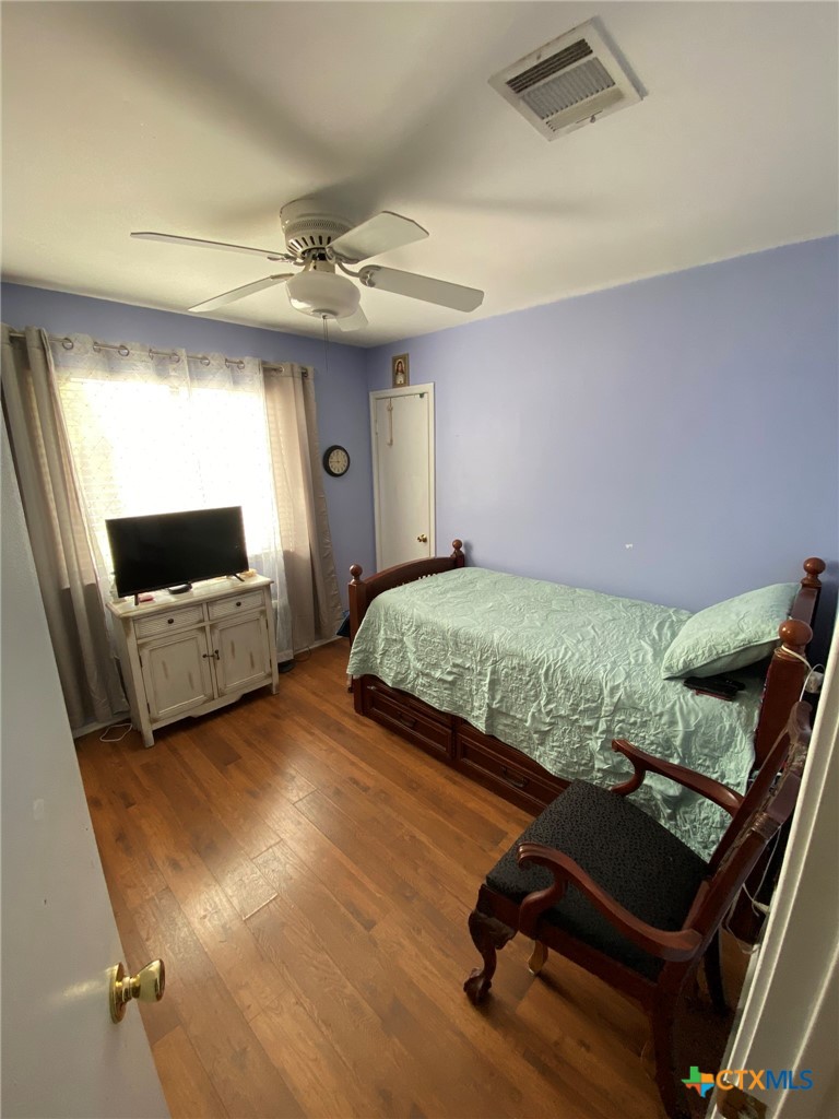 8305 Fort Sumter Road Austin, TX 78745 - Photo 18 of 23 a bedroom with a bed and a flat screen tv