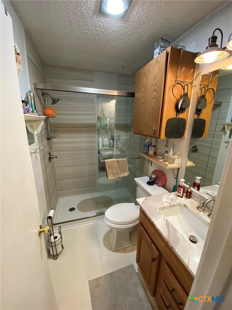 8305 Fort Sumter Road Austin, TX 78745 - Photo 20 of 23 a bathroom with a sink toilet and shower