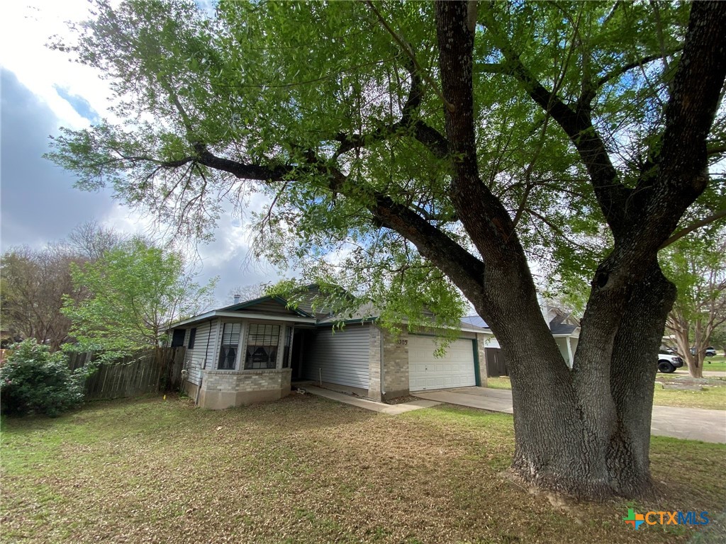 8305 Fort Sumter Road Austin, TX 78745 - Photo 2 of 23 a front view of a house with a yard