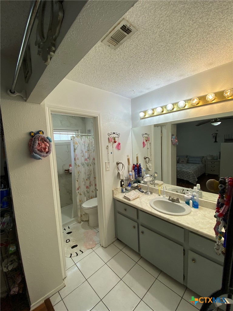 8305 Fort Sumter Road Austin, TX 78745 - Photo 23 of 23 a bathroom with a sink mirror and shower