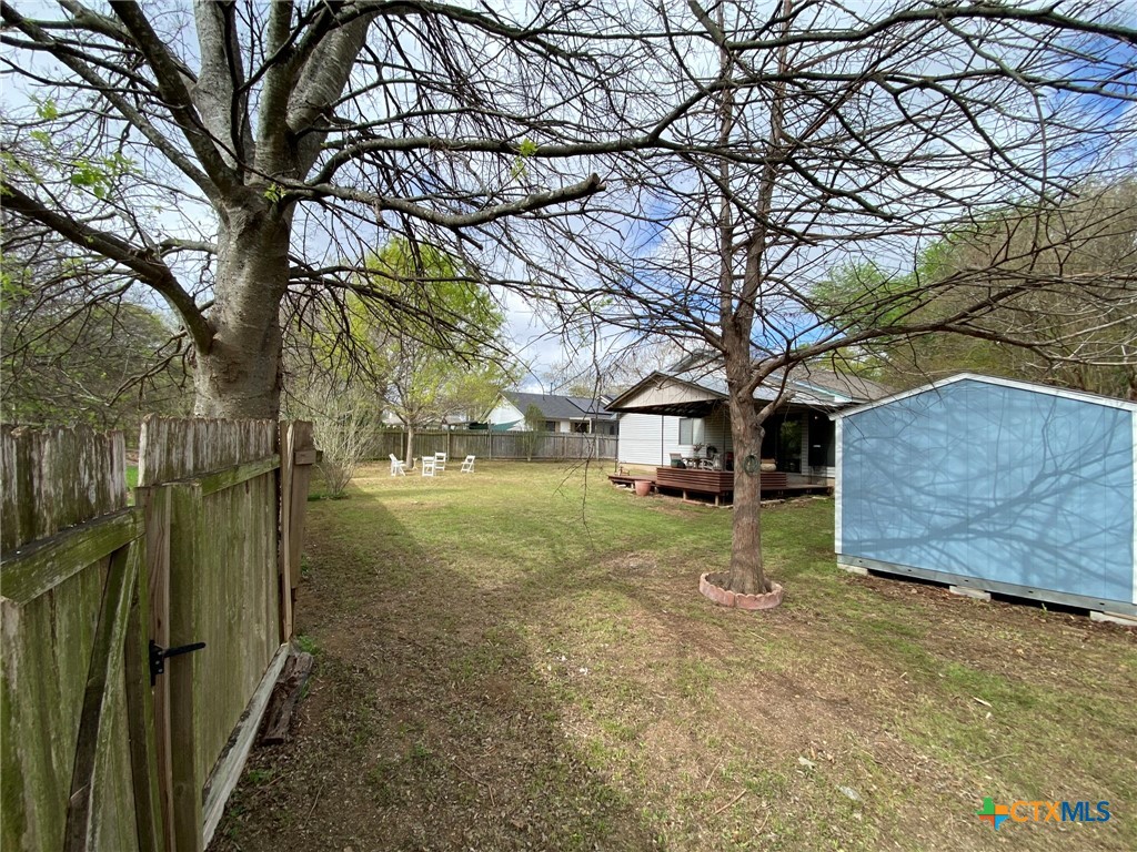 8305 Fort Sumter Road Austin, TX 78745 - Photo 10 of 23 a view of a yard with a house and a large tree