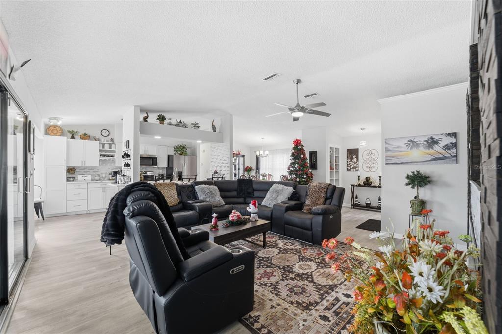 3366 Bluefish Drive Hernando Beach, FL 34607 - Photo 6 of 75 a living room with furniture and a chandelier