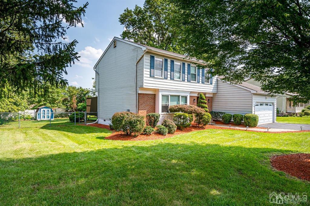 127 Hickory Road Somerset, NJ 08873 - Photo 1 of 51 a front view of a house with a yard and trees
