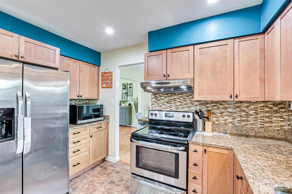 127 Hickory Road Somerset, NJ 08873 - Photo 21 of 51 a kitchen with stainless steel appliances granite countertop a refrigerator sink and stove