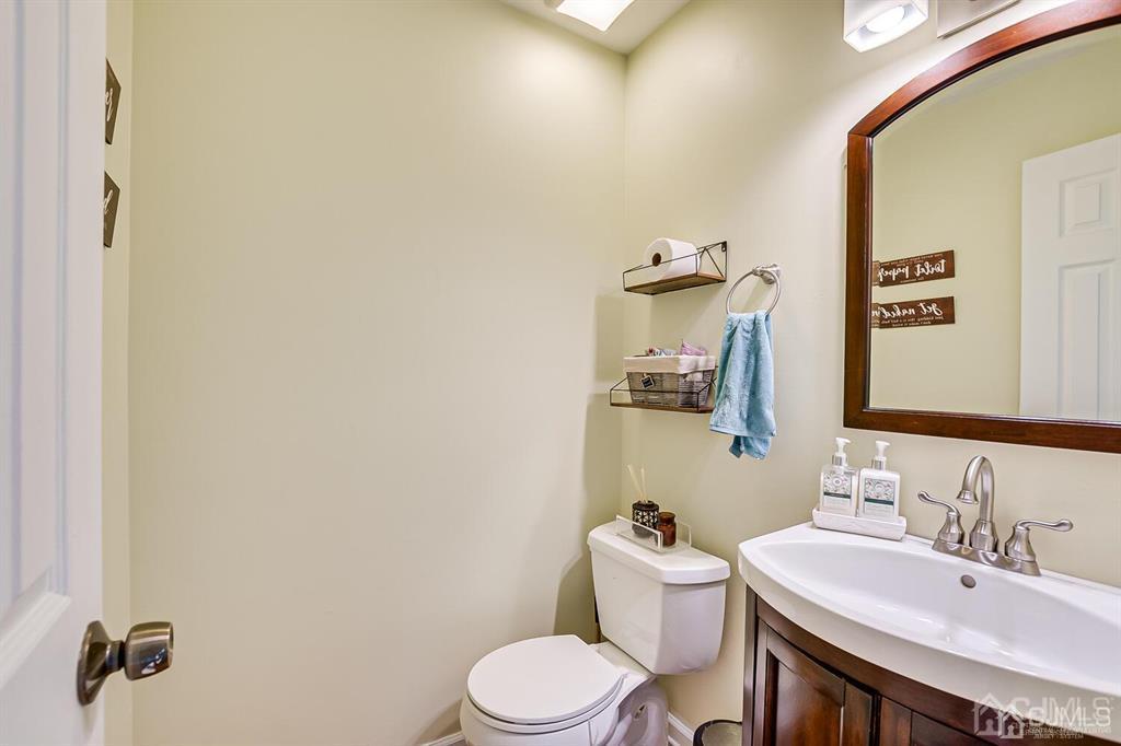 127 Hickory Road Somerset, NJ 08873 - Photo 22 of 51 a bathroom with a sink a toilet and mirror