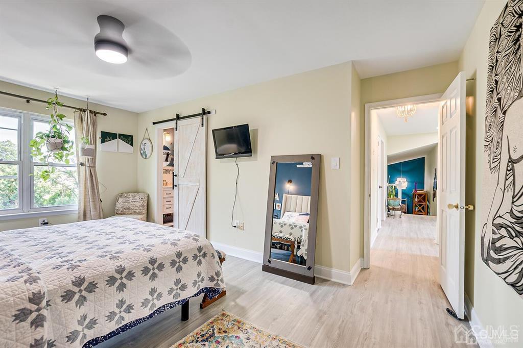 127 Hickory Road Somerset, NJ 08873 - Photo 34 of 51 a bedroom with a bed and a chandelier