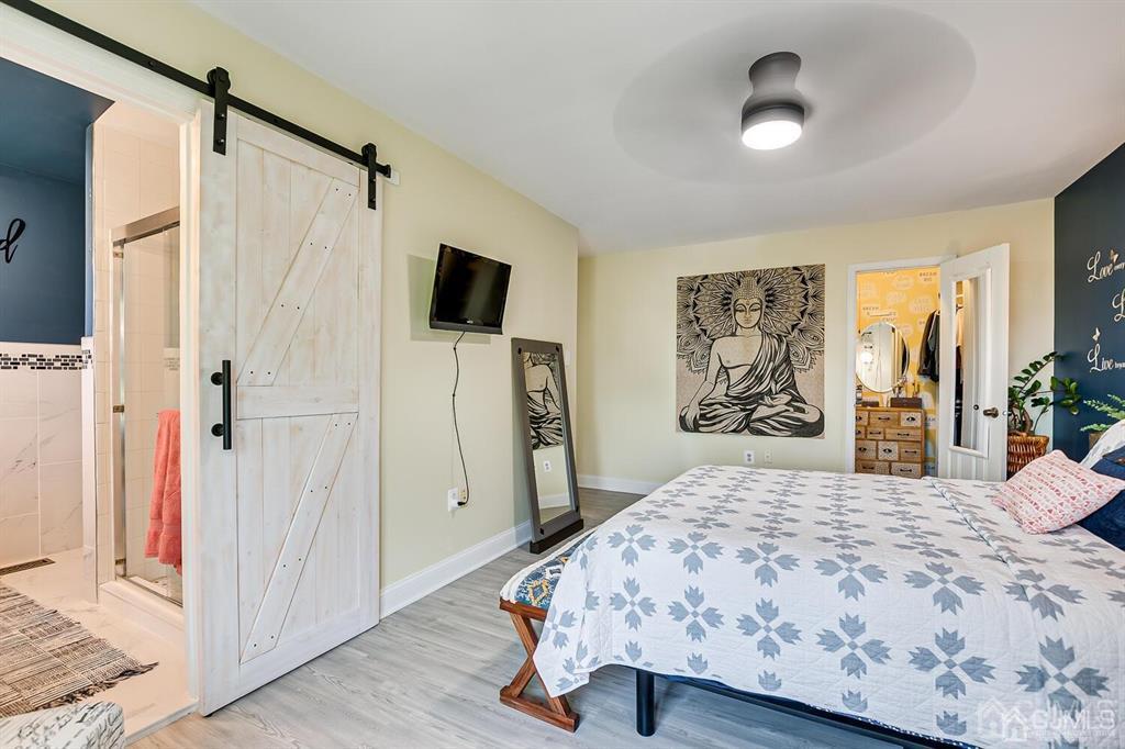 127 Hickory Road Somerset, NJ 08873 - Photo 35 of 51 a bedroom with a bed and a flat screen tv