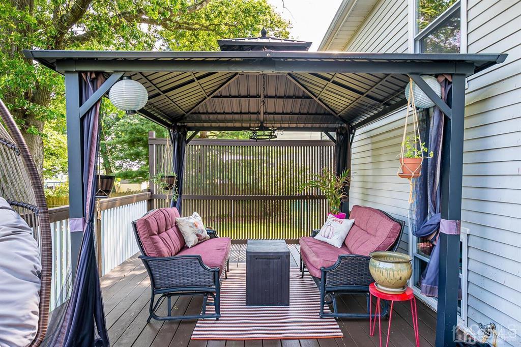 127 Hickory Road Somerset, NJ 08873 - Photo 41 of 51 an outdoor sitting area with furniture and umbrella