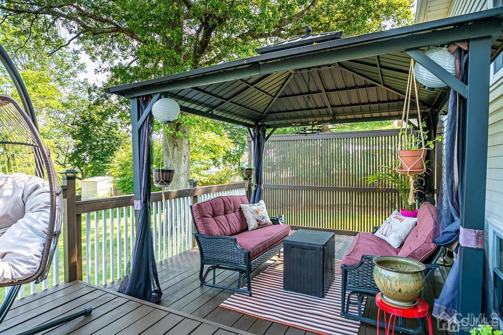 127 Hickory Road Somerset, NJ 08873 - Photo 42 of 51 a patio with wooden floor table and chairs
