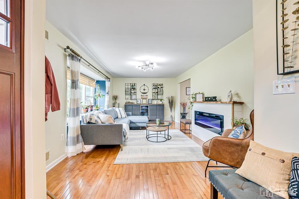 127 Hickory Road Somerset, NJ 08873 - Photo 10 of 51 a living room with fireplace furniture and a wooden floor