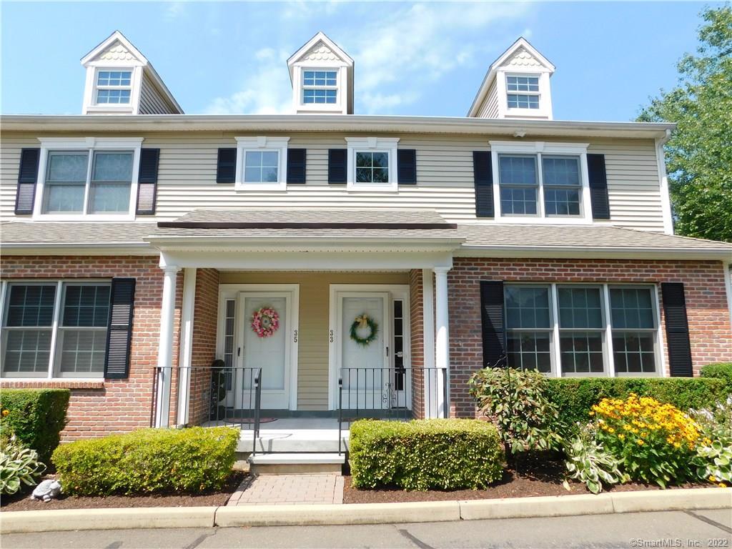 front view of a brick house with a large windows