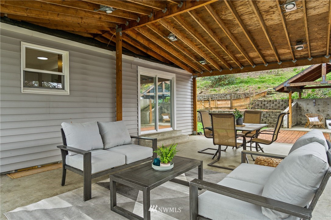 466 Grandey Way Northeast Renton, WA 98056 - Photo 17 of 21 a view of a patio with dining table and chairs with wooden floor