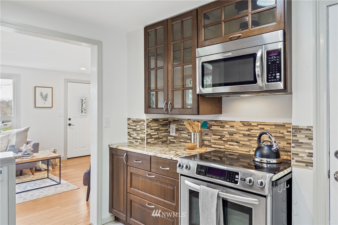 466 Grandey Way Northeast Renton, WA 98056 - Photo 7 of 21 a kitchen with stainless steel appliances a stove microwave and cabinets