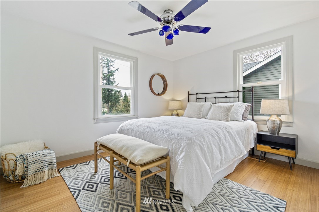 466 Grandey Way Northeast Renton, WA 98056 - Photo 10 of 21 a bedroom with a bed and a table with wooden floor