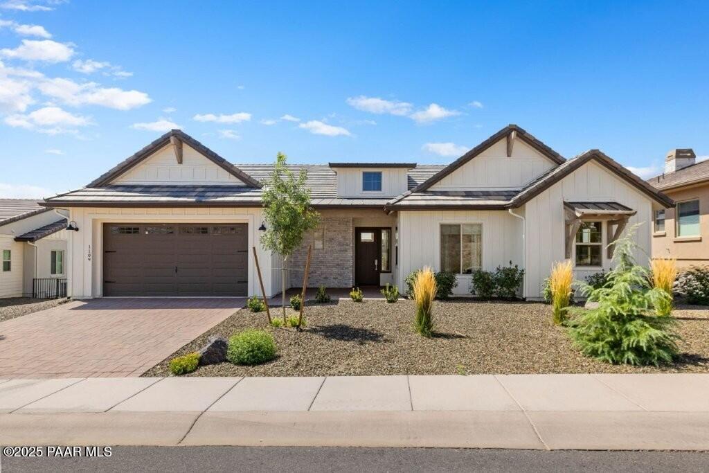 a front view of a house with porch and outdoor seating