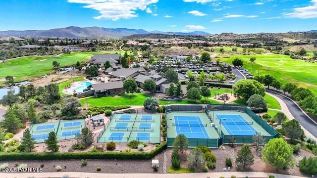 an aerial view of residential houses with outdoor space and street view