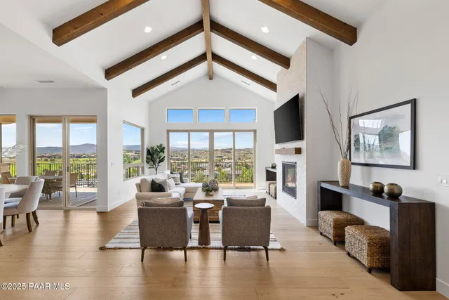 a living room with fireplace furniture and a large window
