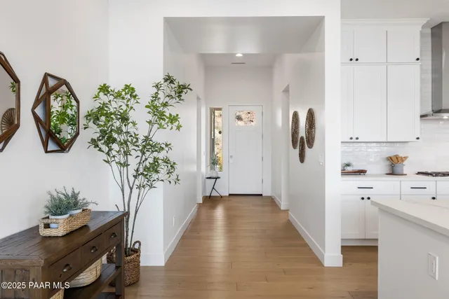 workspace with potted plant wooden floor and a window