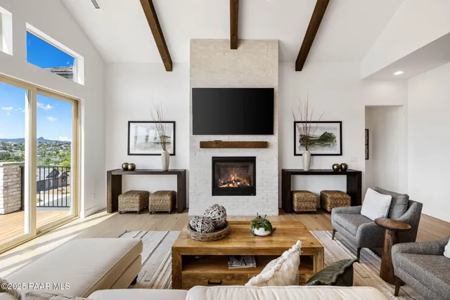 a living room with furniture fireplace and a flat screen tv