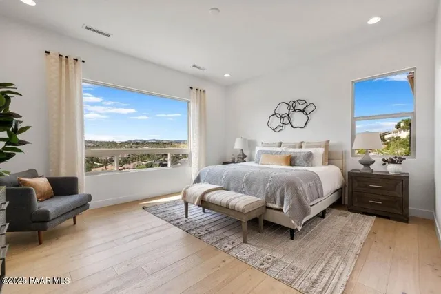 a bedroom with a large bed and a couch