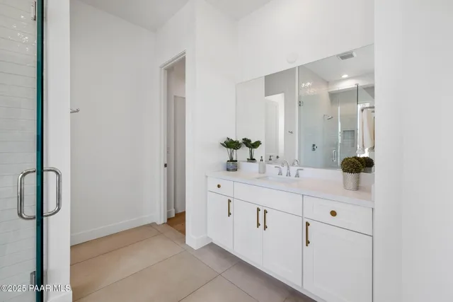 a bathroom with a double vanity sink a and mirror