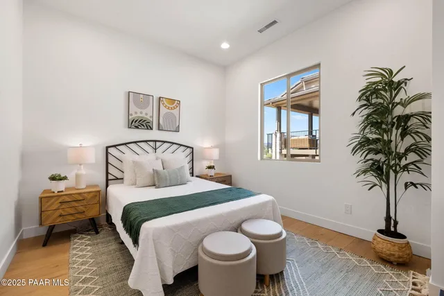 a bedroom with a bed and a potted plant