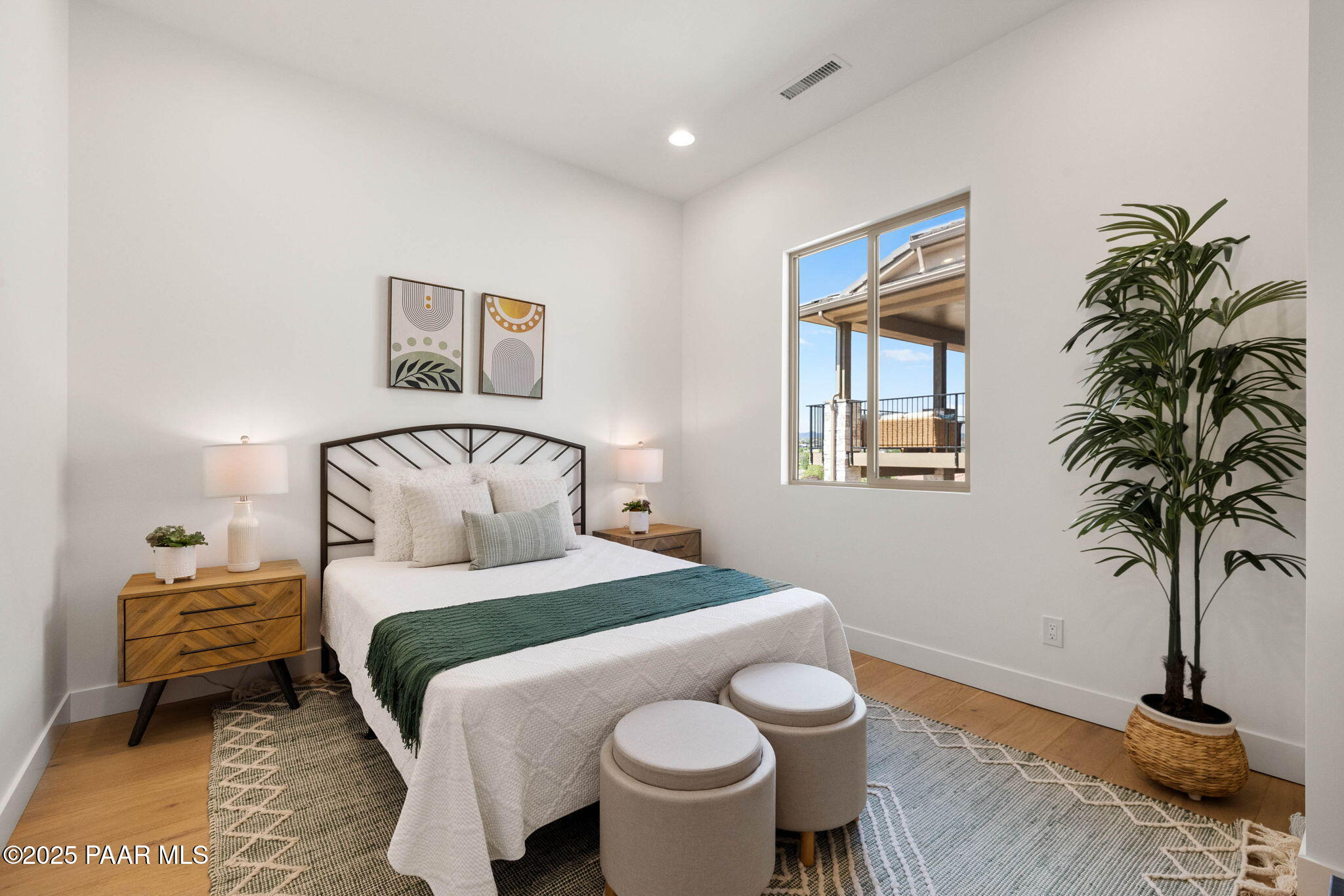 1109 South Lakeview Drive Prescott, AZ 86301 - Photo 33 of 48 a bedroom with a bed and a potted plant