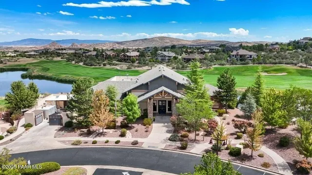 a view of a house with a yard and sitting area