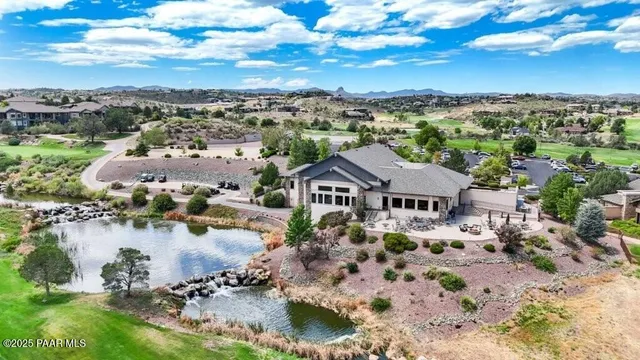 an aerial view of residential houses with outdoor space and river