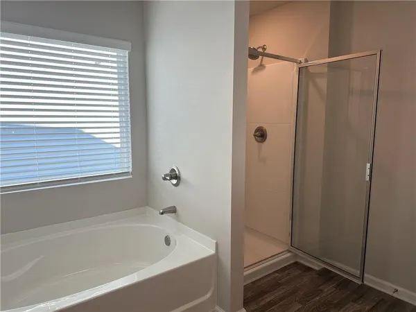 a bathroom with a bathtub and a shower