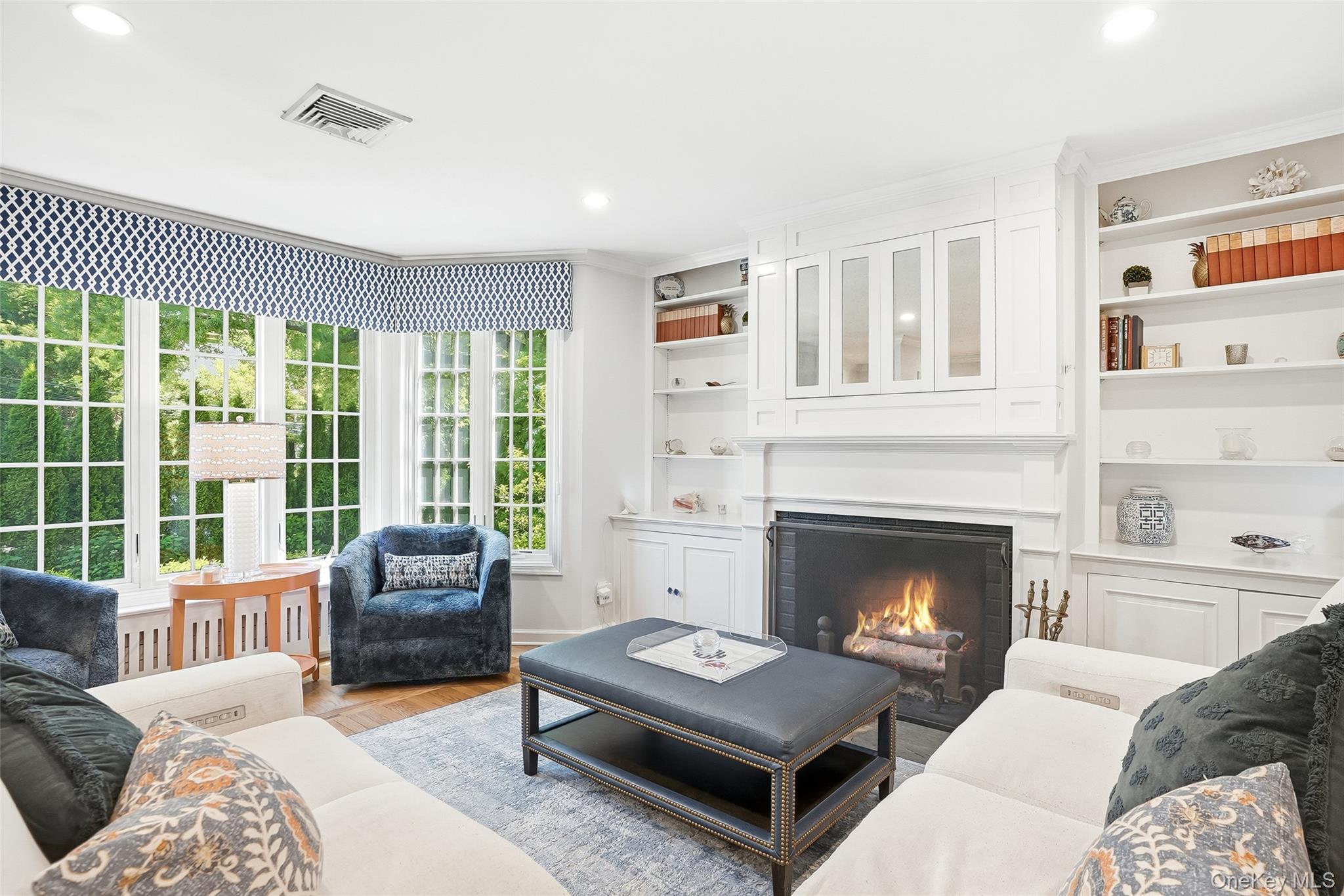 5 Mayfield Street Rye, NY 10580 - Photo 4 of 35 Living Room features custom built-ins (yes, there is a TV hiding behind that cabinet over the fireplace) and a wall of windows