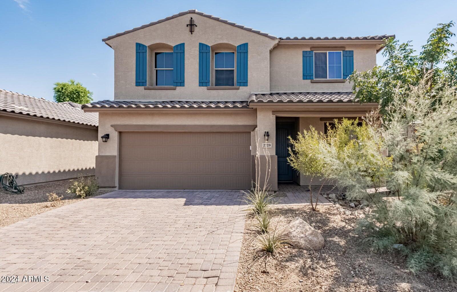 a front view of a house with a yard and garage