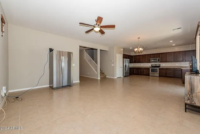 a view of kitchen with furniture and a ceiling fan