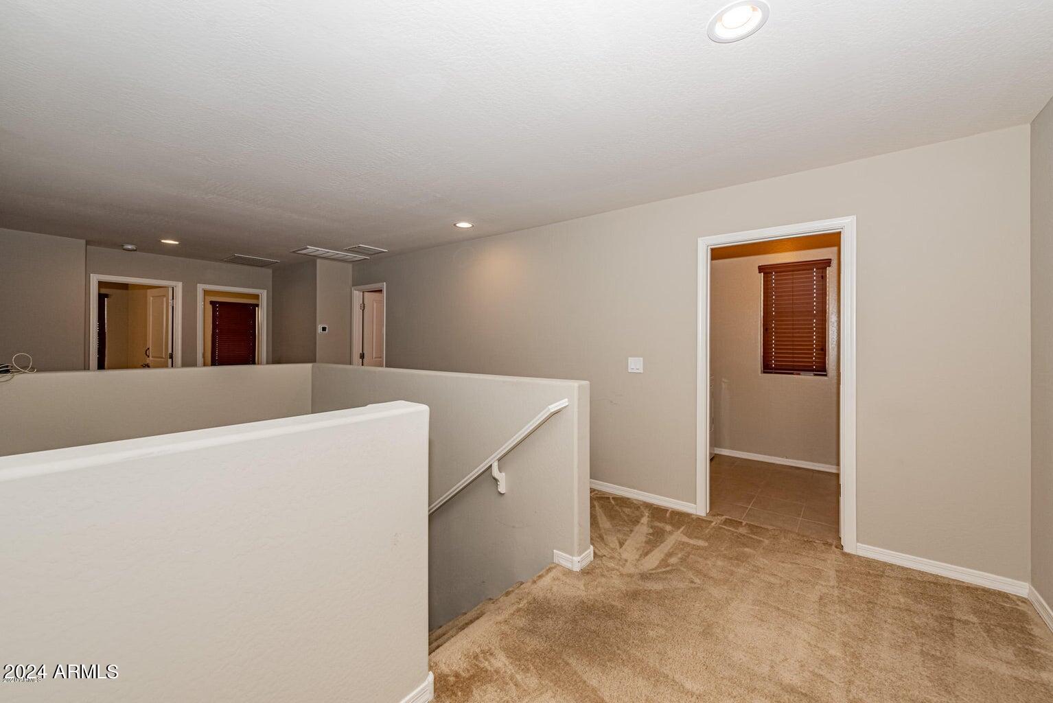 2729 East Dunbar Drive Phoenix, AZ 85042 - Photo 14 of 29 a view of a kitchen with wooden floor and more cabinets