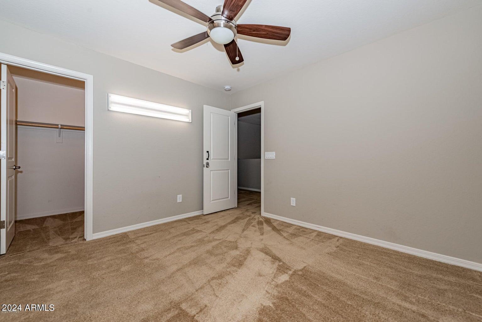 2729 East Dunbar Drive Phoenix, AZ 85042 - Photo 15 of 29 an empty room with closet and windows