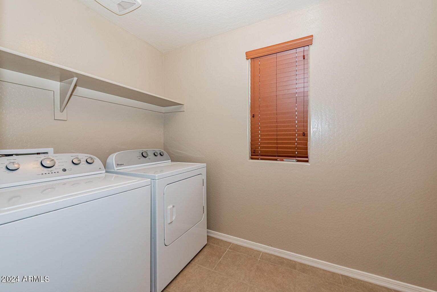2729 East Dunbar Drive Phoenix, AZ 85042 - Photo 16 of 29 a view of storage and utility room with washer and dryer