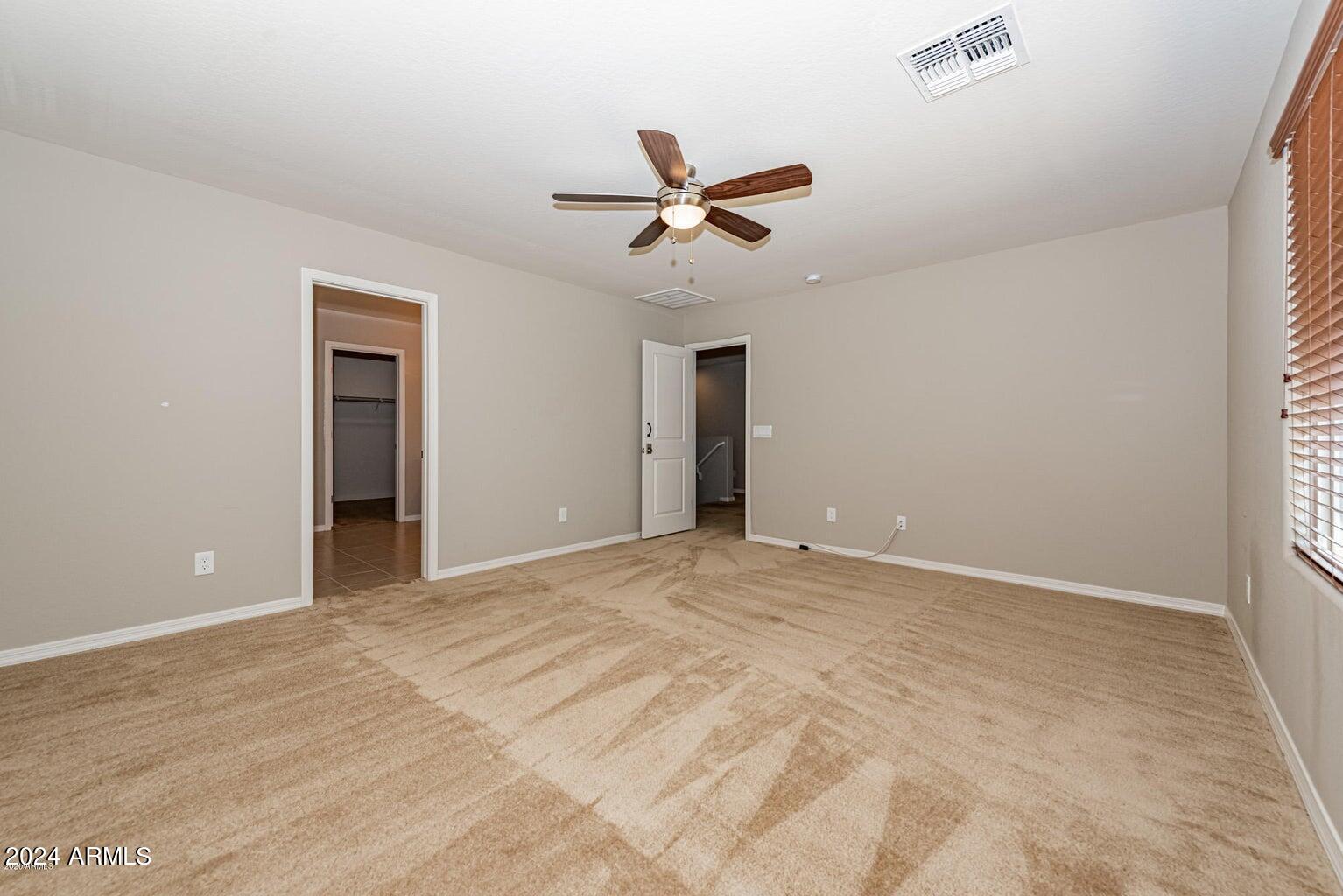 2729 East Dunbar Drive Phoenix, AZ 85042 - Photo 18 of 29 a view of an empty room with a ceiling fan