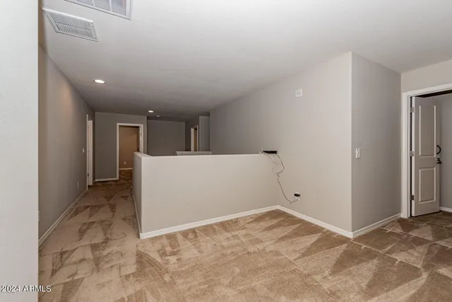 a view of a big room with closet and windows