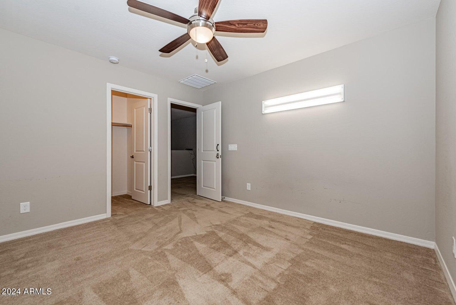 2729 East Dunbar Drive Phoenix, AZ 85042 - Photo 24 of 29 an empty room with chandelier fan