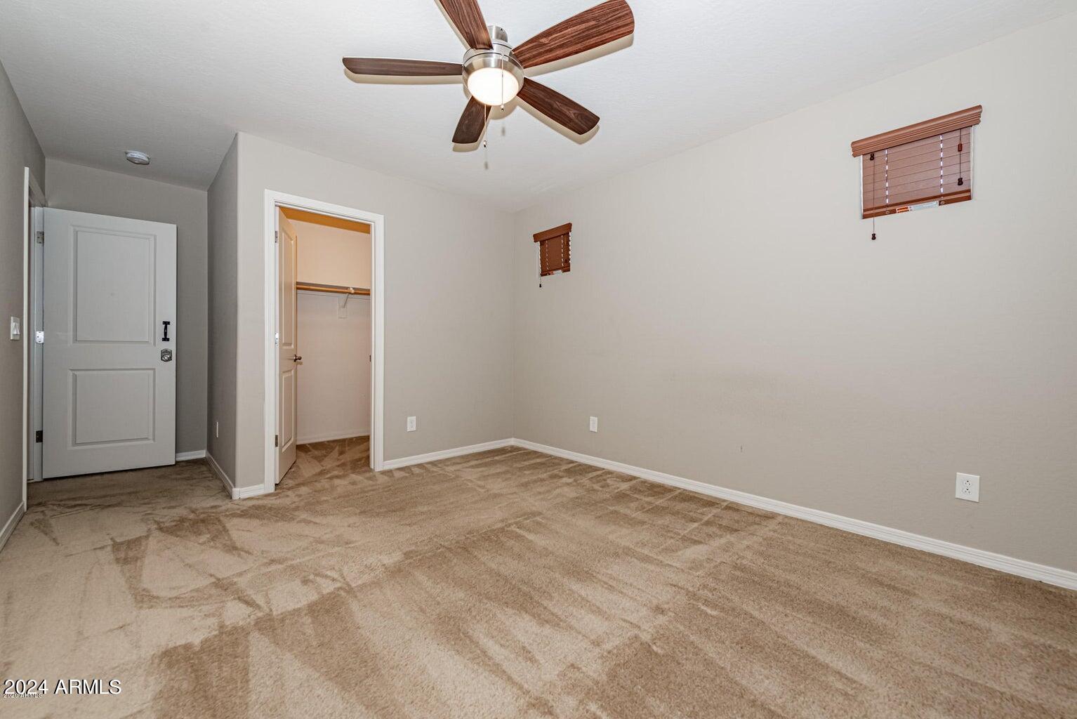 2729 East Dunbar Drive Phoenix, AZ 85042 - Photo 26 of 29 an empty room with closet and a ceiling fan
