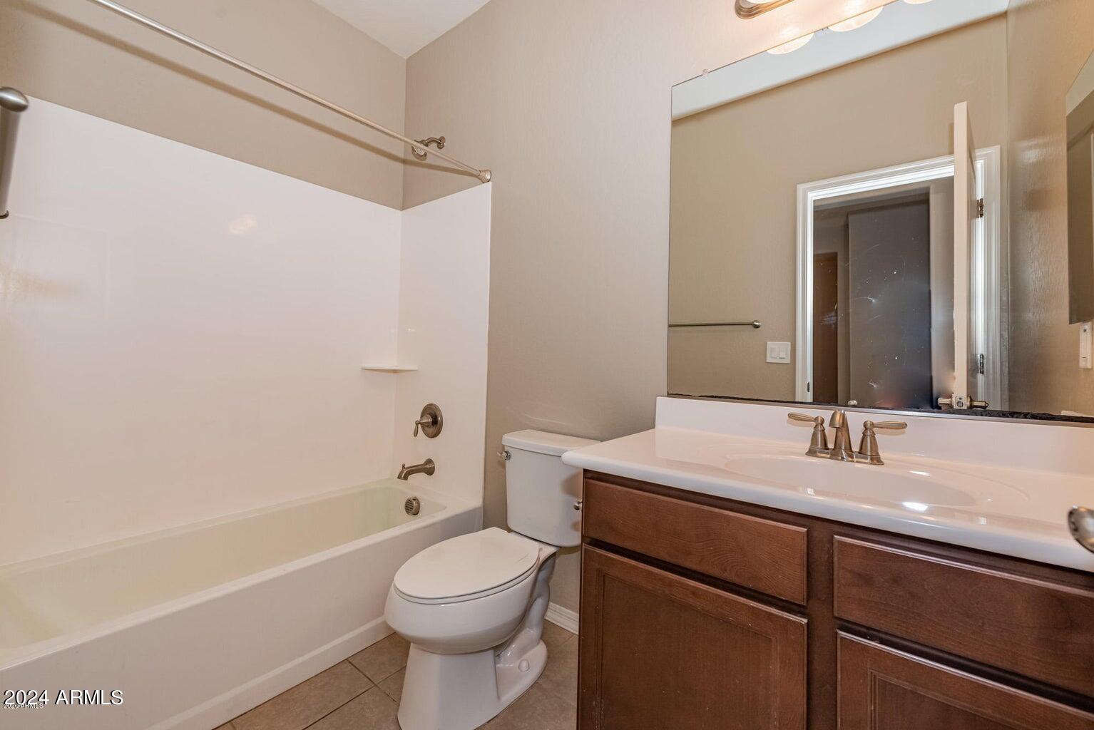 2729 East Dunbar Drive Phoenix, AZ 85042 - Photo 4 of 29 a bathroom with a sink a toilet and shower