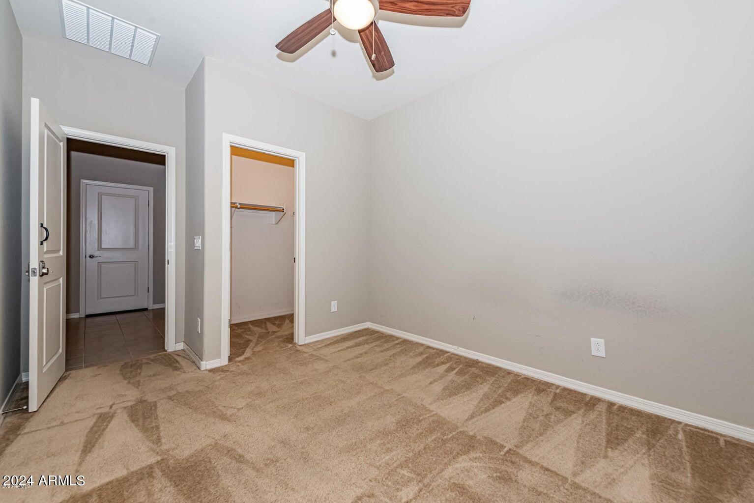 2729 East Dunbar Drive Phoenix, AZ 85042 - Photo 5 of 29 an empty room with closet and windows