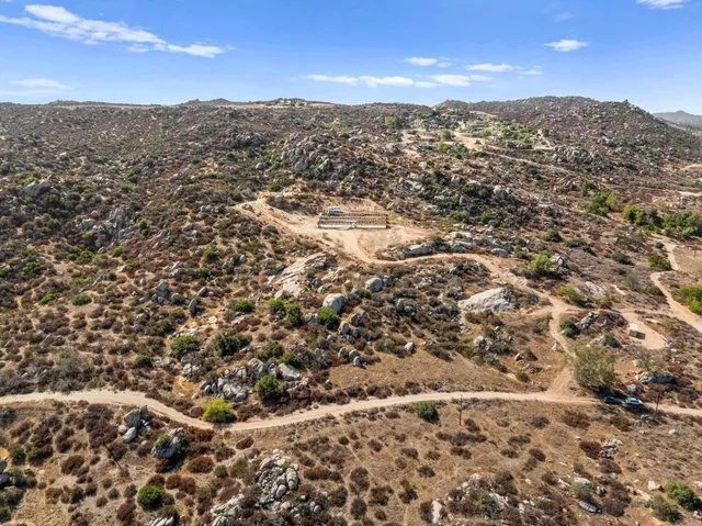an aerial view of residential houses with city view