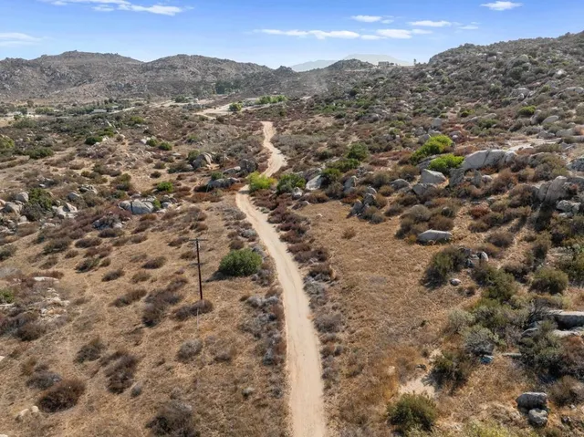 an aerial view of residential houses with city view