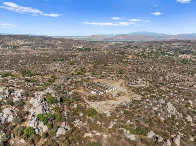 an aerial view of residential houses with city view