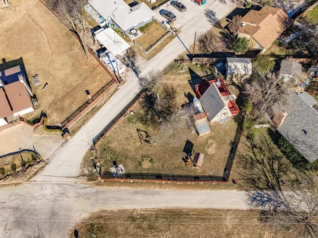 an aerial view of a house with a yard