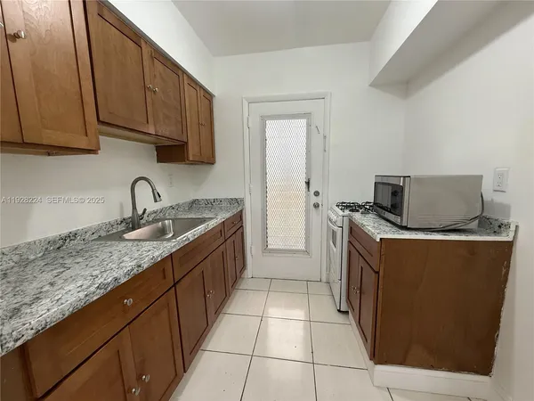 a kitchen with stainless steel appliances granite countertop a sink and cabinets