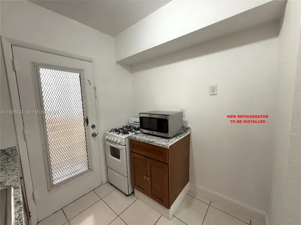 a kitchen with a stove and a microwave